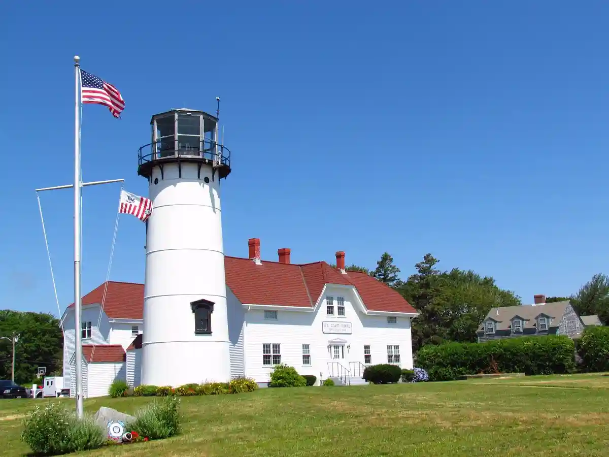 Chatham Lighthouse with American flag on a sunny Cape Cod day