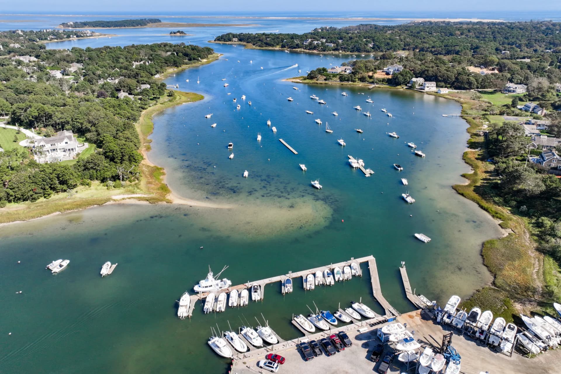 Aerial view of Chatham harbor with boats at moorings and marina dock