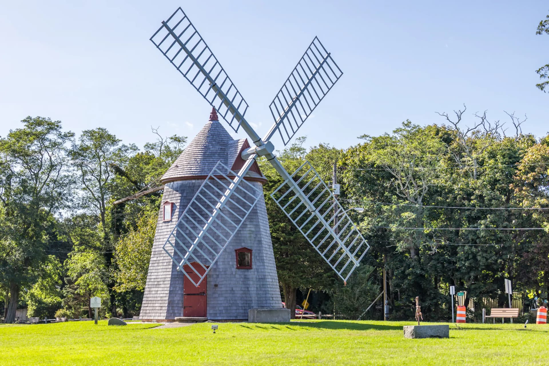Historic Eastham Windmill on a green lawn surrounded by trees