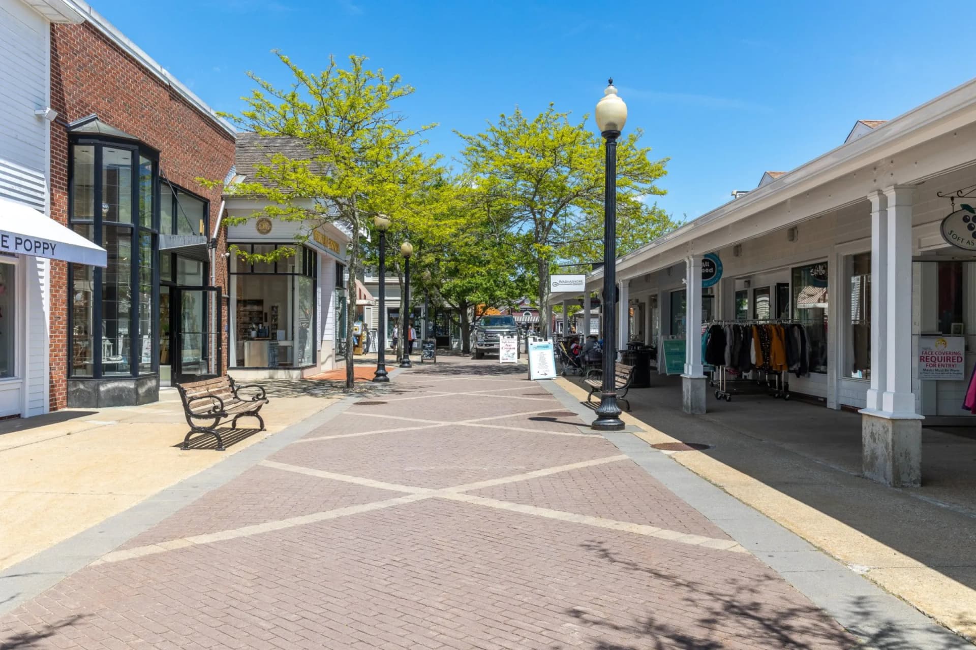 Mashpee Commons outdoor shopping walkway with boutique shops and spring trees