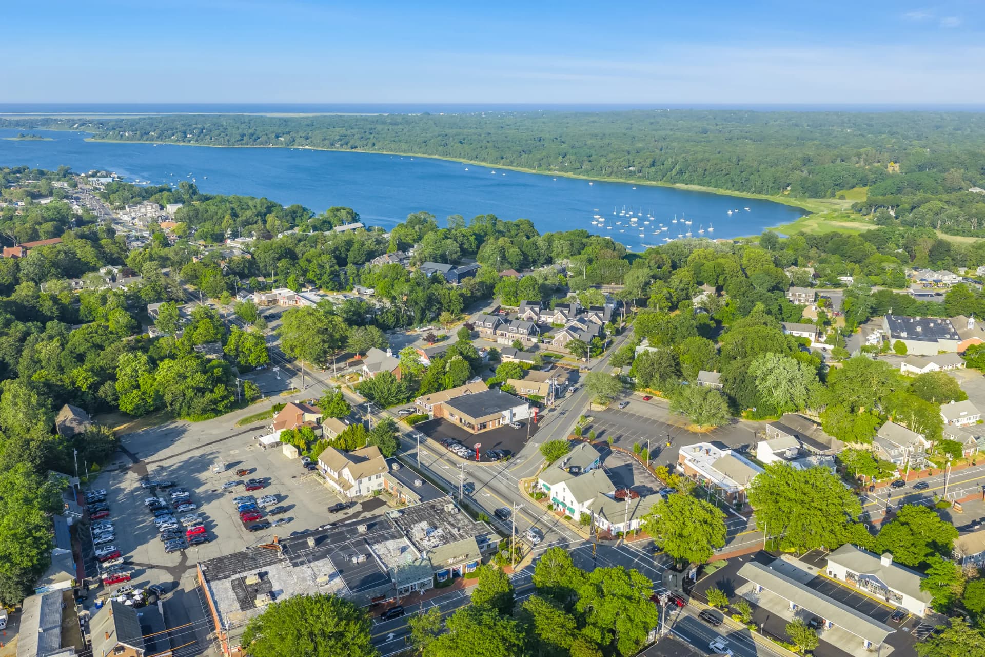 Aerial view of Orleans town center with Pleasant Bay and sailboats beyond