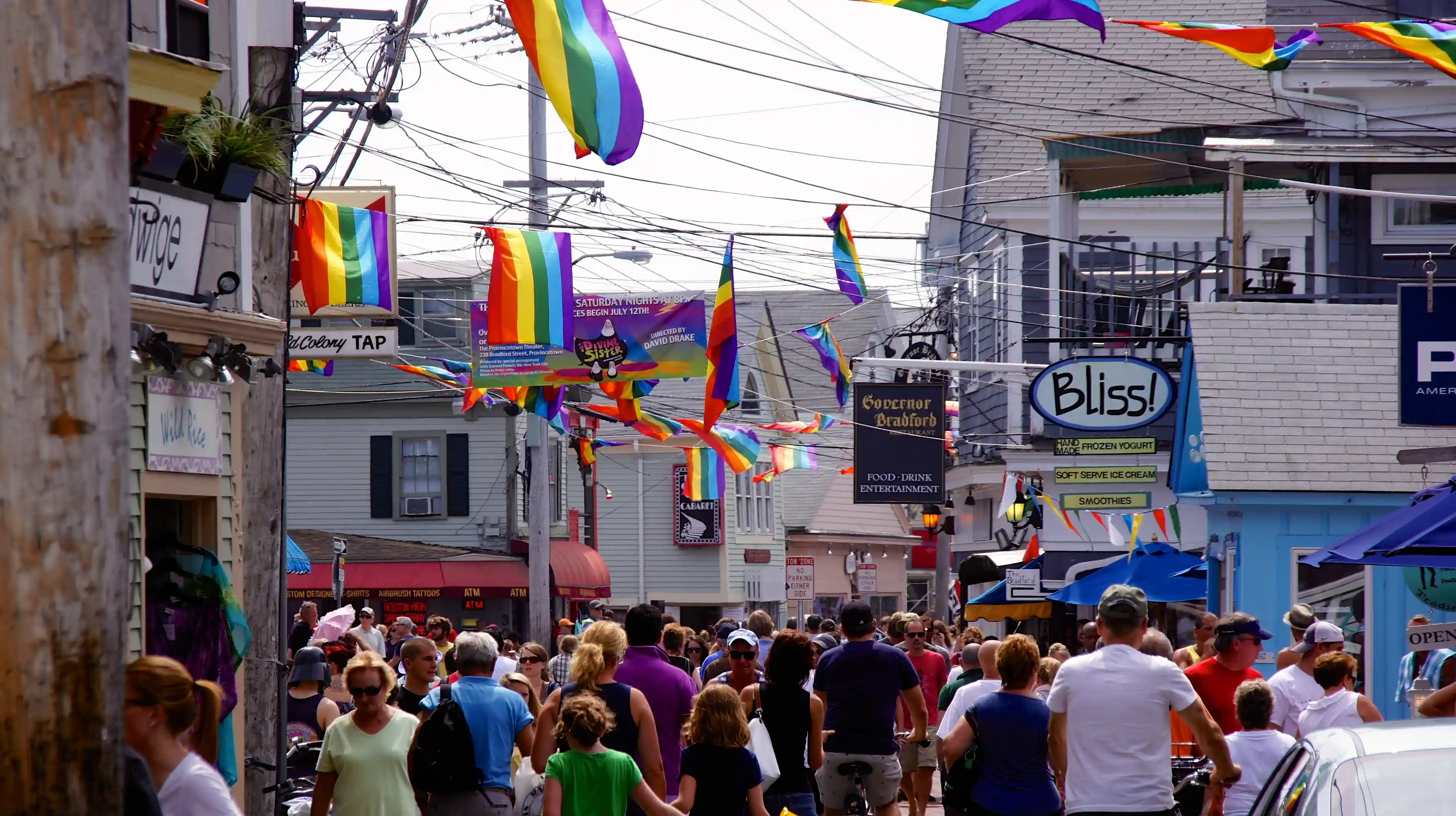 Provincetown Commercial Street with art galleries, Pilgrim Monument, and dramatic dunes