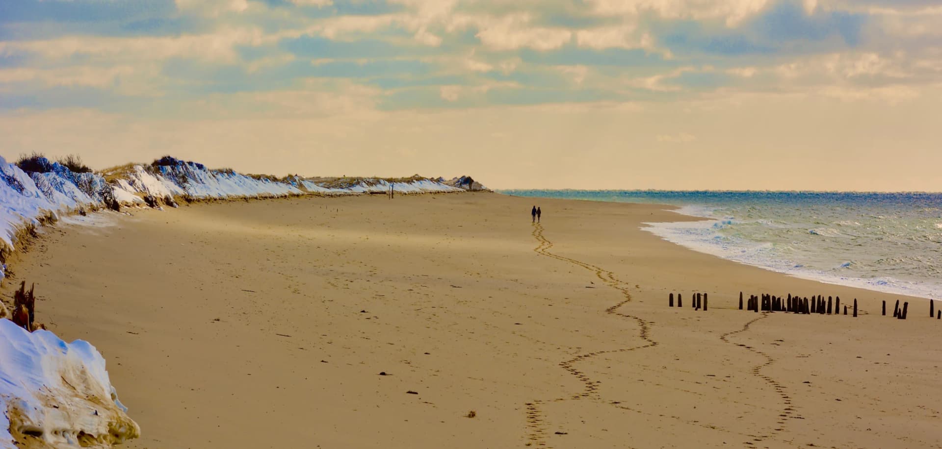 Winter beach on the Outer Cape with footprints in the sand
