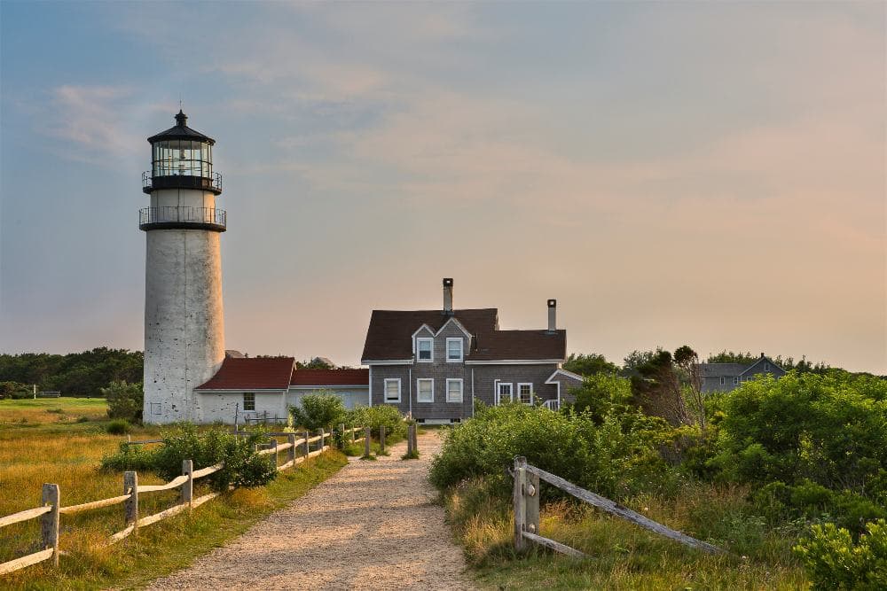 Highland Light on dramatic cliffs with sweeping ocean and bay views